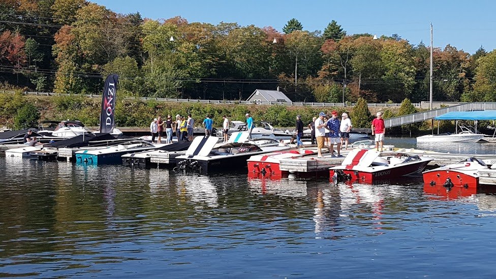 People gathering on a dock with boats