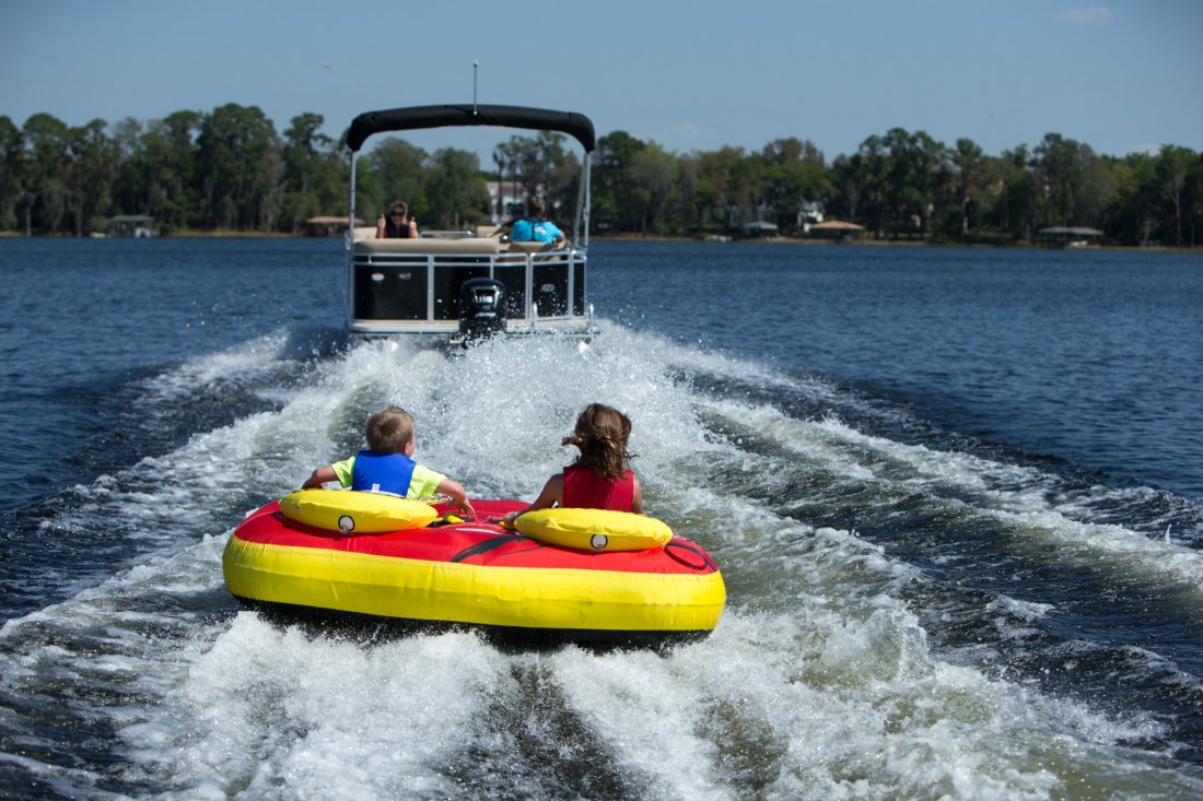 Two kids going tubing with their parents